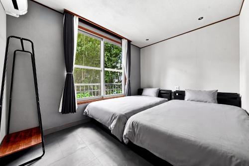 a bedroom with a bed and a window at THE GRANDEUR in Sapporo