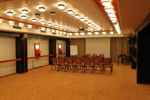 a meeting room with a table and chairs in it at Hotel Jasmine in Braşov