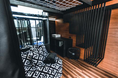 a bedroom with a bed in a room with wooden walls at Private Cabin for Quiet, Extended, Freescape Stays in Cavinti