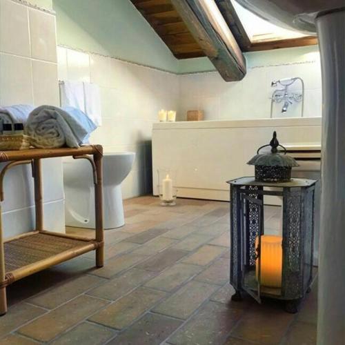 a room with a bathroom with a toilet and a table at Casa Tentoni - Guest House in Misano Adriatico