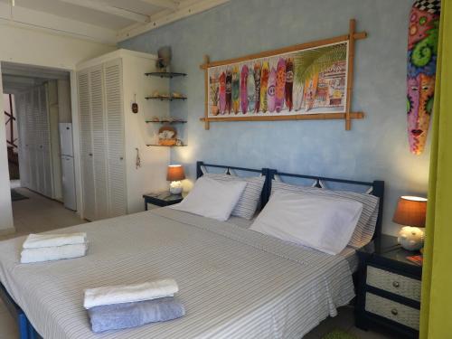 a bedroom with a bed with two towels on it at Green Garden Apartment in Christ Church