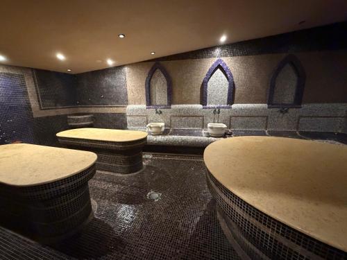 a bathroom with two sinks and two stools at Pirin Getaway Heaven in Razlog