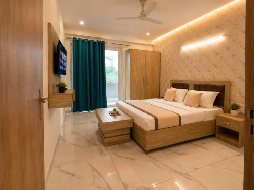 a bedroom with a bed and a television in it at Hotel Akshay dream stay in Gurgaon