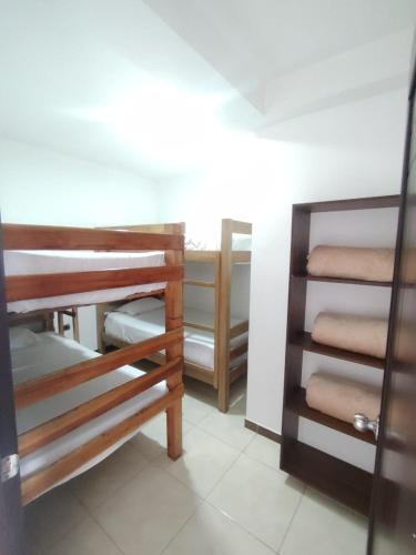 a room with wooden bunk beds in a room at Apartamentos El paraiso cerca a Termales - cerca al centro - se aceptan mascotas in Santa Rosa de Cabal