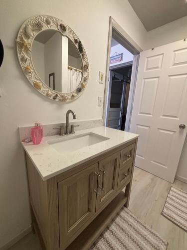 a bathroom with a sink and a mirror at The conch cottage in Crystal River