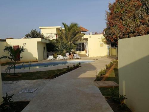 a house with a swimming pool next to a house at Villa Du Soleil Ngaparou in Ngaparou