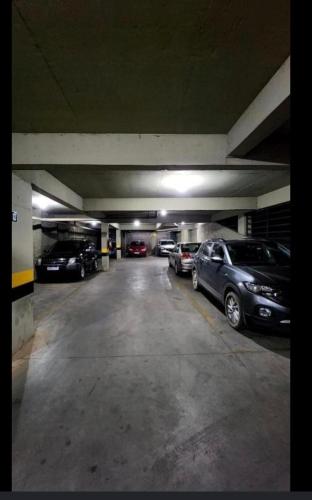 a parking garage with several cars parked in it at Edifício Paris 411 in Lagoa Santa
