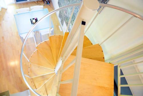 a spiral staircase in a house with a person taking a picture at Barton Hills Condominiums in Austin