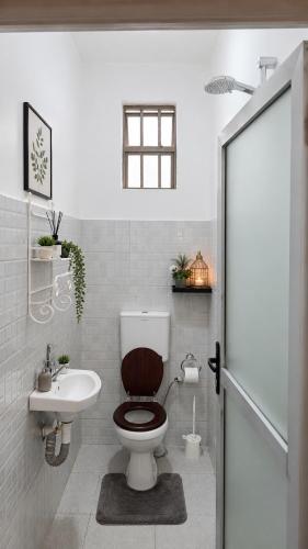 a bathroom with a toilet and a sink at Imanis comfort in Ongata Rongai 
