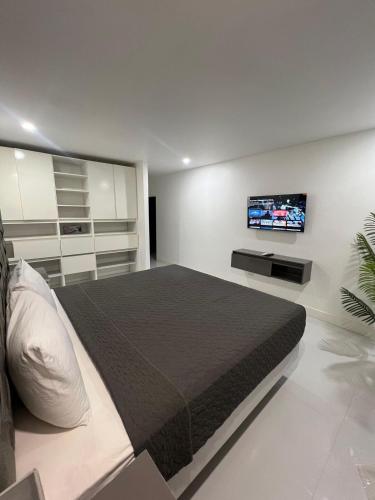 a bedroom with a bed and a tv on the wall at Deluxe two 2 bedroom in Priory