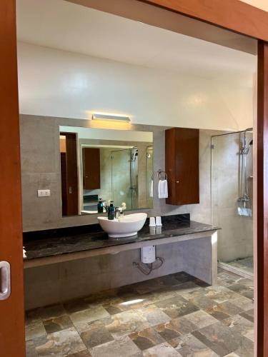 a bathroom with a sink and a mirror at Infinity Heights Resort in Siquijor