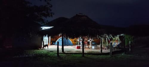 a playground at night with a straw umbrella at Finca LA HERMOSA in Guzmán