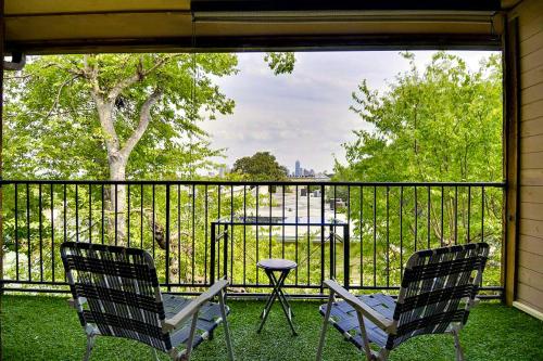 two chairs and a table on a balcony with a table at Barton Hills Condominiums in Austin