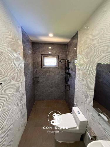 a bathroom with a toilet and a sink and a mirror at Coco Villa in Hinkong
