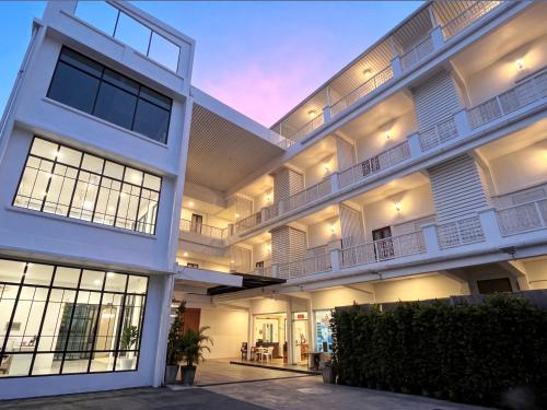 an exterior view of a large white building at Excel Hotel Bangkok former Sri Krungthep Hotel in Bangkok