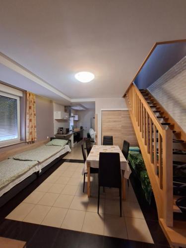 a room with a bed and a table and a staircase at Noclegi Dobrzeń Wielki in Dobrzeń Wielki