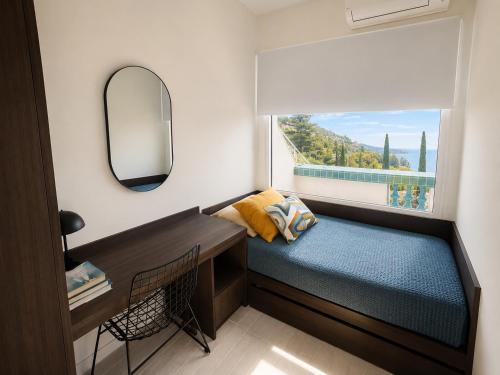 a small bedroom with a bed and a mirror at New - sea view - splendid apartment in Nice