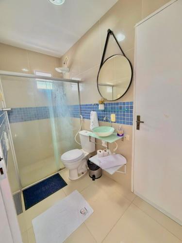 a bathroom with a shower and a toilet and a mirror at Flat Carneiros - Hotel Marinas in Tamandaré