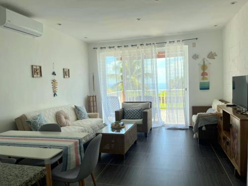 a living room with a couch and a table at Perfect Paradise, Oceanview in Samana in Santa Bárbara de Samaná