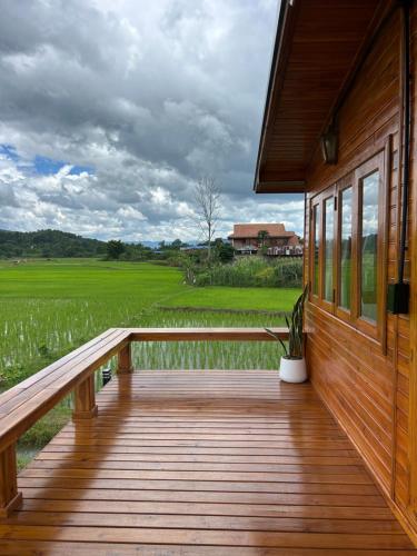 a porch of a house with a potted plant on it at Nonnatatonview นอนนาตาทนวิว in Phayao