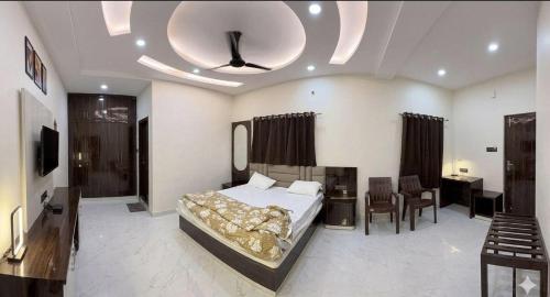 a bedroom with a bed and a room with a mirror at Hotel Friends Residency in Bijaipur