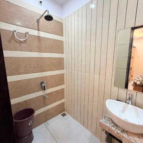 a bathroom with a sink and a mirror at Hotel Friends Residency in Bijaipur
