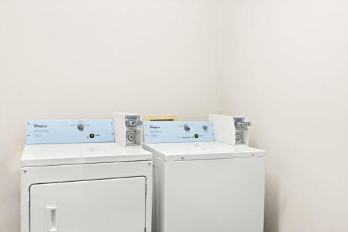 a white washer and dryer in a room at Sonesta Essential Savannah in Savannah