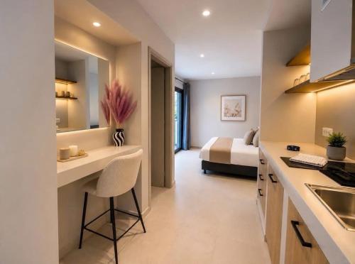 a kitchen and a bedroom with a bed in a room at Aristomenis Studios in Vlachata