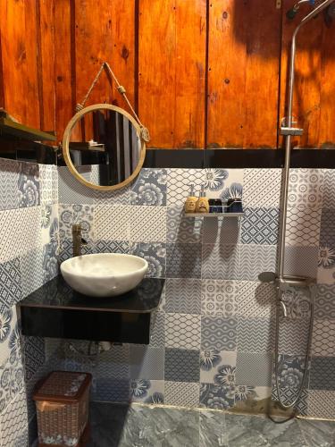 a bathroom with a sink and a mirror at Twin Double Room in Phú Ngọc (1)