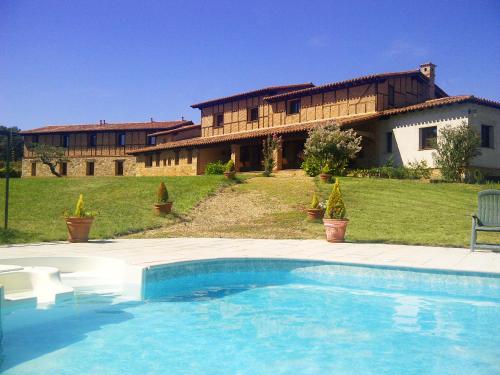 a swimming pool in front of a house at Alcor del Roble in Collado