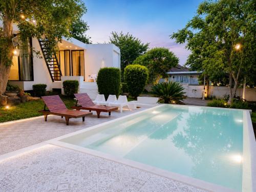 a swimming pool in the backyard of a house at Pony Hill Villa in Bophut