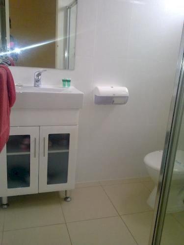 a white bathroom with a sink and a toilet at Renmark Motor Inn in Renmark