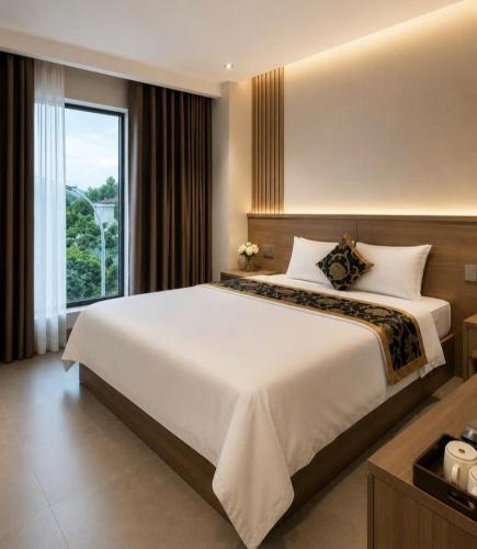 a bedroom with a large bed and a large window at An Bình Luxury Hotel in Bắc Giang