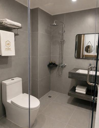a bathroom with a toilet and a glass shower at An Bình Luxury Hotel in Bắc Giang