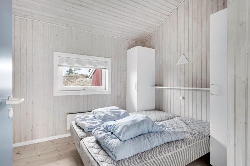 a bedroom with a bed and a window at Holiday House On Fanø Near The Sea in Fanø