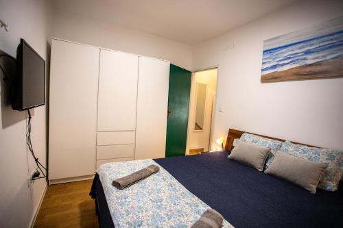 a bedroom with a bed and a flat screen tv at Casa Nora in centre of Vodnjan - Happy Rentals in Vodnjan