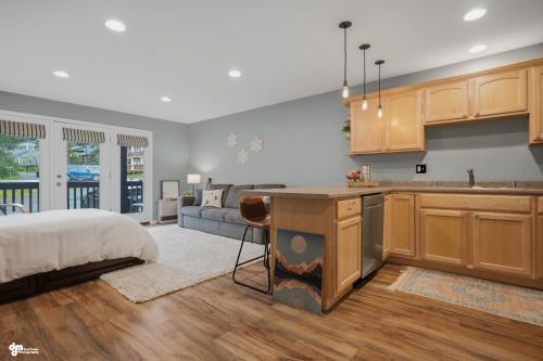 a kitchen and living room with a bed and a kitchen and a couch at Alyeska Mountain Side Retreat! in Girdwood