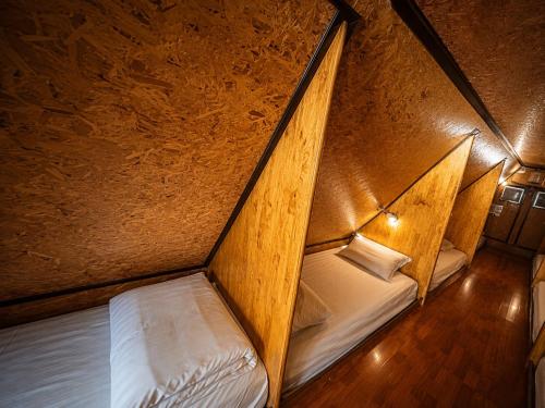 a small room with two beds in a cave at Sukhum Ban Songthai in Bangkok
