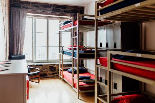 a room with bunk beds with a large window at Alt Hostel in Montreal