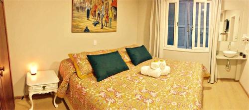 a bedroom with a bed with a stuffed animal on it at Hospedaria Conceitual in Florianópolis