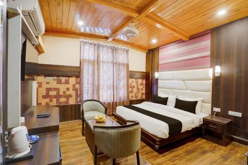 a hotel room with a bed and a desk at Palette Hotel Regency Valley View Pahalgam By CheckIn in Batakūt