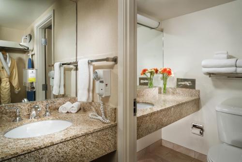 a hotel bathroom with two sinks and a toilet at Staypineapple, University Inn, University District Seattle in Seattle