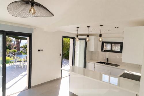 a kitchen with white walls and a ceiling at Villa 6 pers à 30m de la mer in Sainte-Maxime