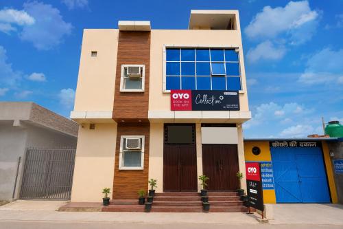 a house with a sign on the front of it at OYO Collection O Kalyanpur Metro Station in Kaliānpur