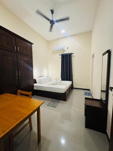 a bedroom with a bed and a ceiling fan at nama villa in Arugam Bay