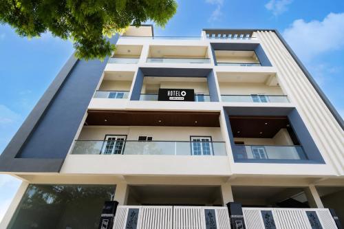 an apartment building with a sign that reads hive at Super Hotel O Temple Road Vemulavada in Karīmnagar