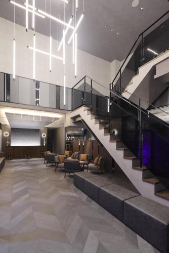 a staircase in a building with a lobby at GRIDS PREMIUM HOTEL OSAKA NAMBA in Osaka