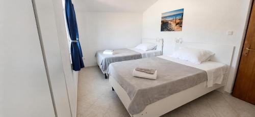 a room with two beds in a room at Family and pet friendly apartment Frankopan Croatia in Šmrika