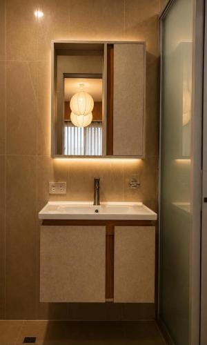 a bathroom with a sink and a mirror at Casa Andrea Bukidnon in Impasugong
