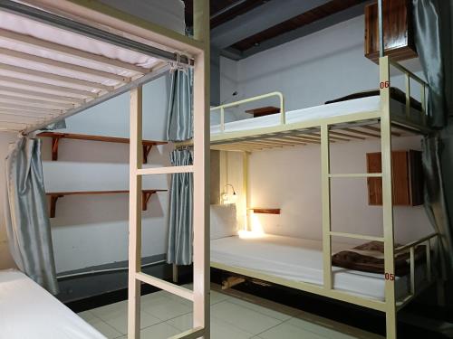 a couple of bunk beds in a room at City Backpackers Hostel in Luang Prabang